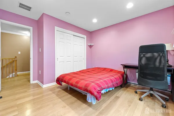 a bedroom with a bed and a couch