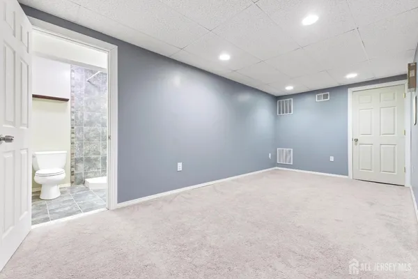 a large white building with a large pool in front of it