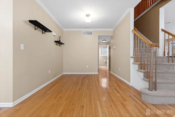 a view of entryway and hall with wooden floor