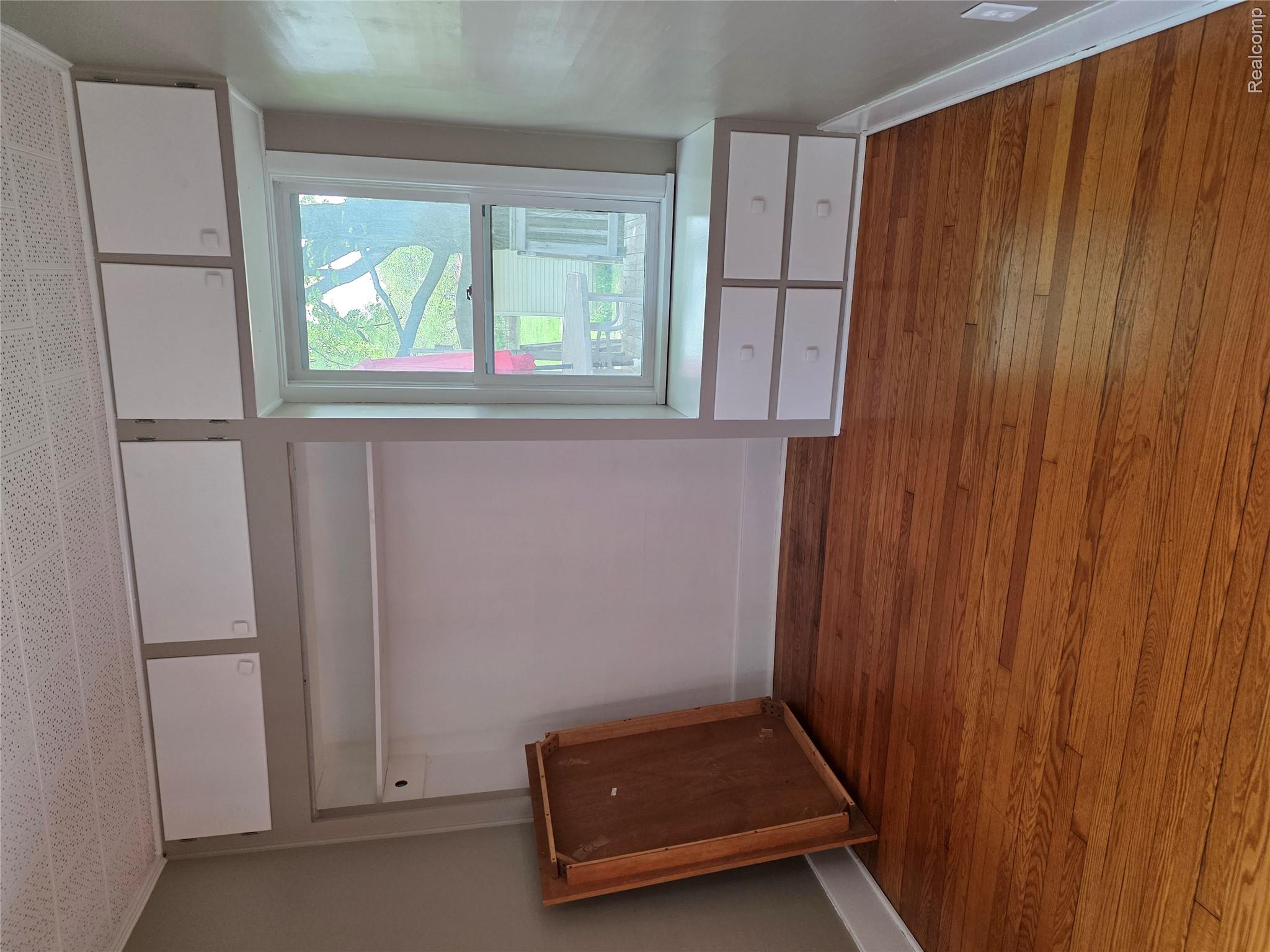 403 East Road Holly, MI 48442 - Photo 21 of 22 Unfurnished bedroom with baseboards and dark wood finished floors