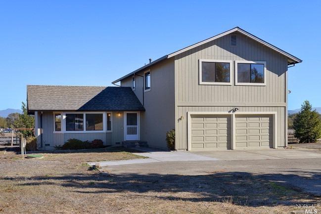 4977 Refugio Road Santa Rosa, CA 95401 - Photo 1 of 1 a front view of a house with a yard and garage