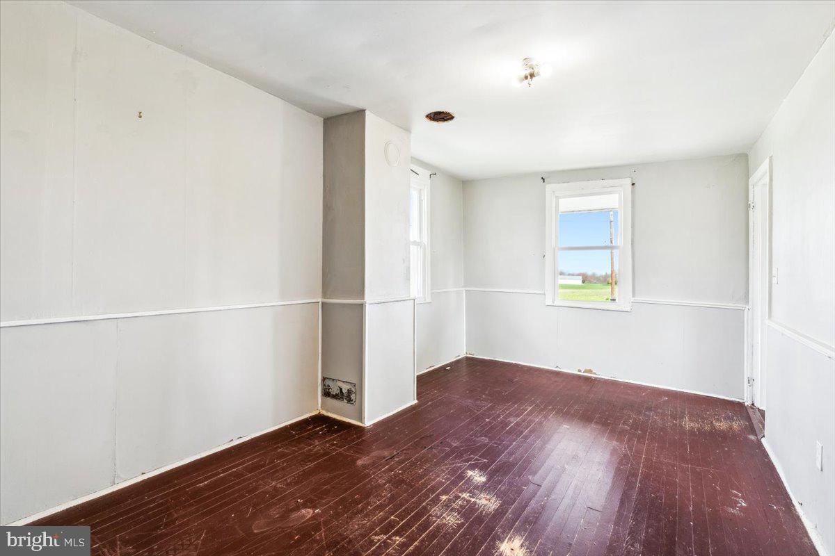 12446 Renner Road Keymar, MD 21757 - Photo 12 of 40 an empty room with wooden floor and windows