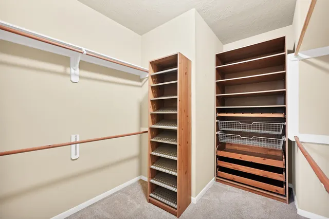a view of walk in closet with empty racks