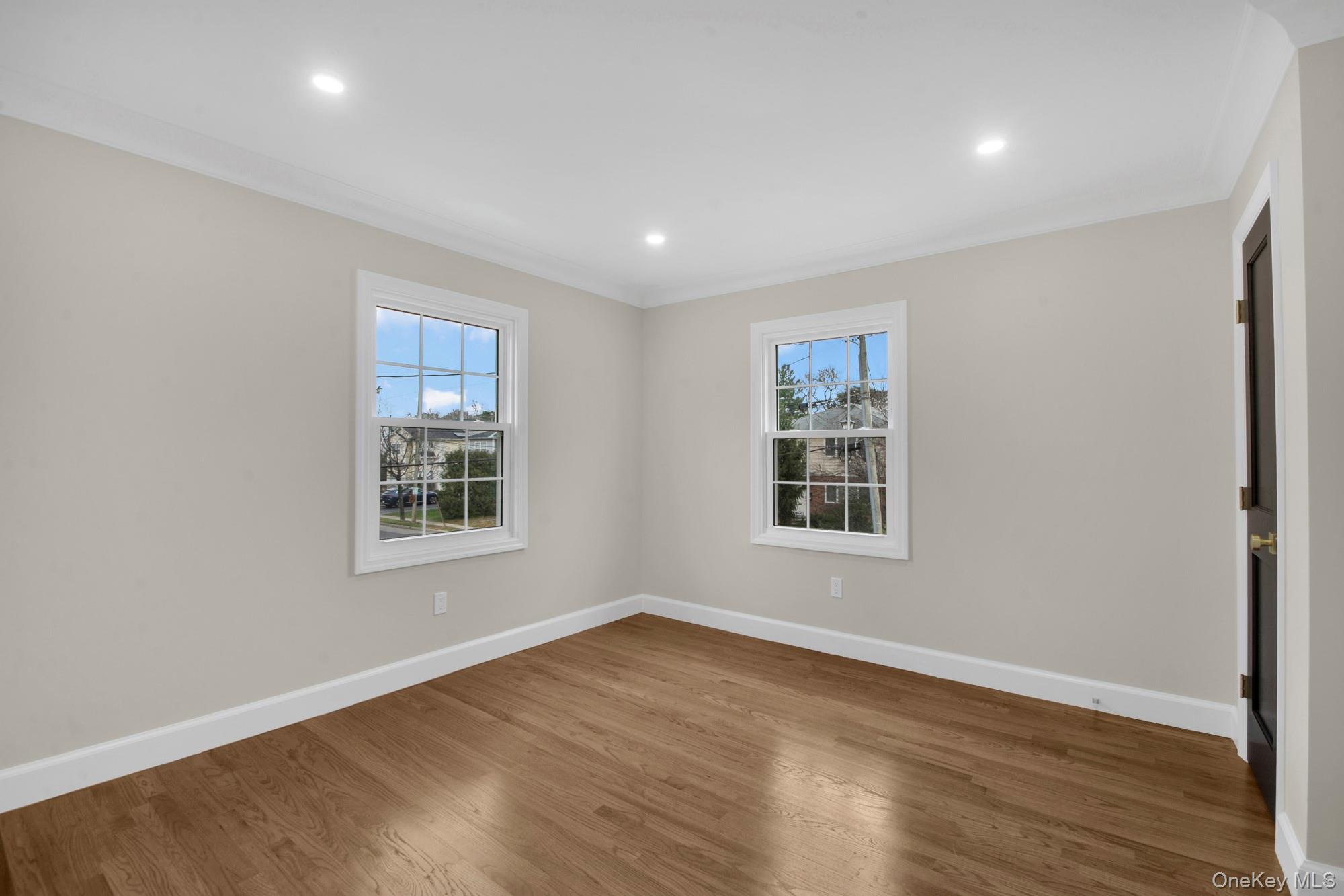 2 Bayview Court Manhasset, NY 11030 - Photo 14 of 21 Corner bedroom with wood finished floors, crown molding, plenty of natural light, and recessed lighting