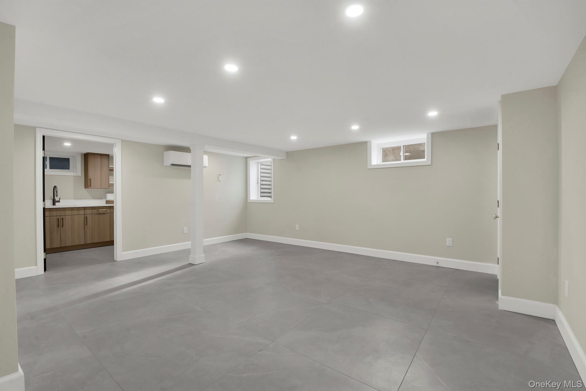 2 Bayview Court Manhasset, NY 11030 - Photo 15 of 21 Lower level with recessed lighting and a wall mounted air conditioner