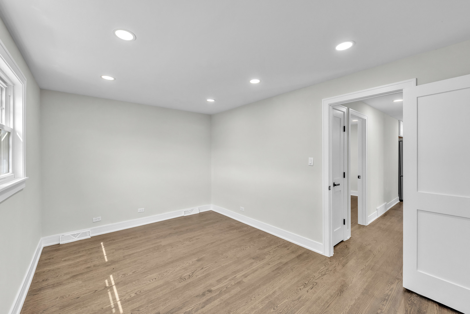 5331 West 53rd Place Chicago, IL 60638 - Photo 12 of 28 an empty room with wooden floor and windows