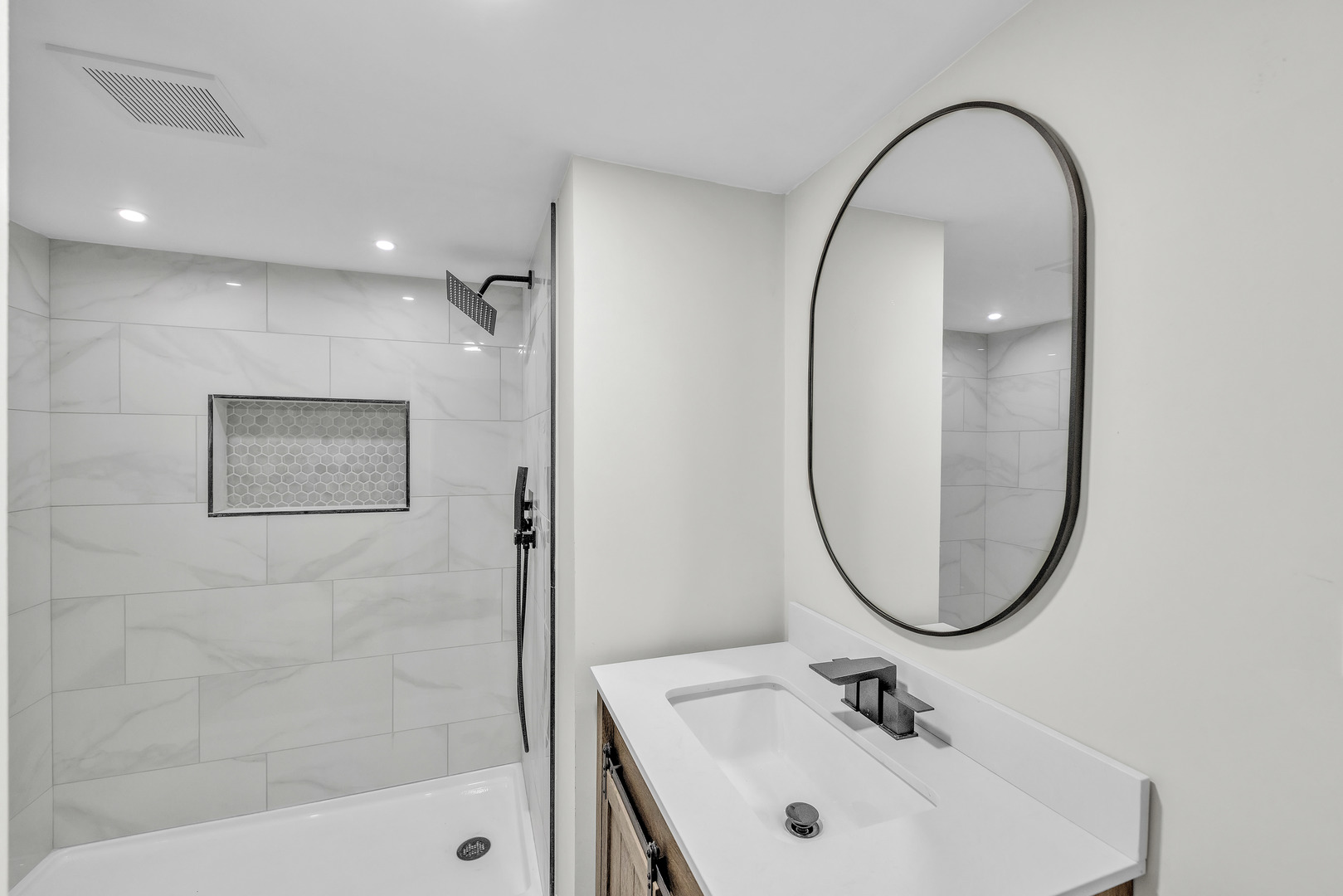 5331 West 53rd Place Chicago, IL 60638 - Photo 22 of 28 a bathroom with a sink a mirror a glass door a shower and a mirror