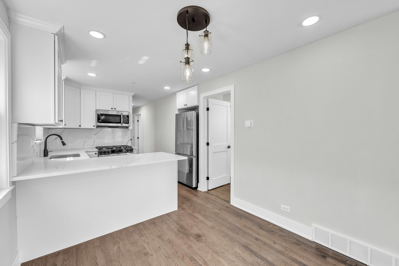 5331 West 53rd Place Chicago, IL 60638 - Photo 5 of 28 a kitchen with stainless steel appliances granite countertop a sink a refrigerator and a stove