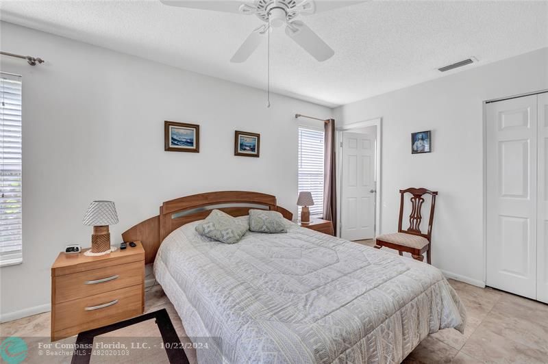 7359 Pine Park Drive North Lake Worth, FL 33467 - Photo 20 of 47 a bedroom with a bed and a chandelier