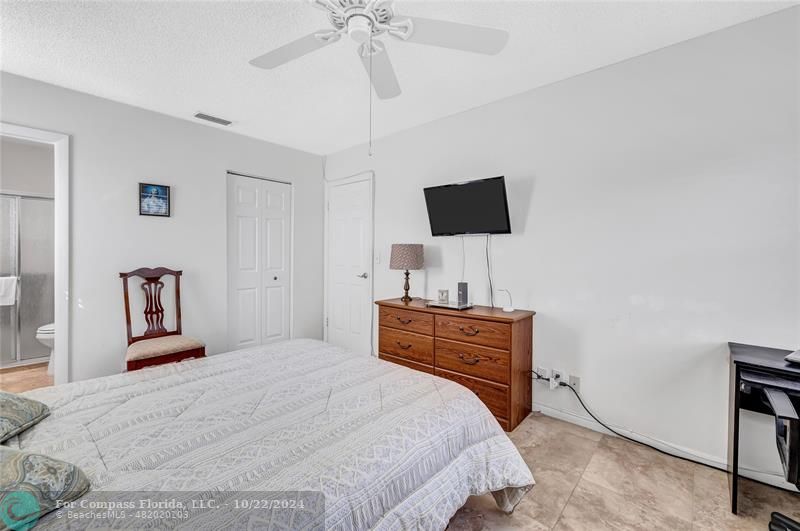 7359 Pine Park Drive North Lake Worth, FL 33467 - Photo 21 of 47 a bedroom with a bed and a flat screen tv