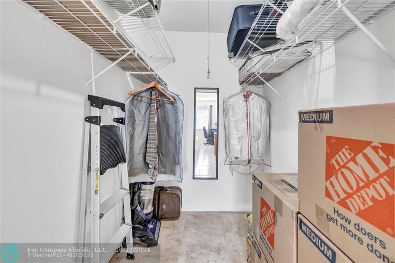 7359 Pine Park Drive North Lake Worth, FL 33467 - Photo 22 of 47 a view of walk in closet with clothes and shoes