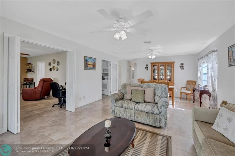 7359 Pine Park Drive North Lake Worth, FL 33467 - Photo 27 of 47 a living room with furniture and a chandelier