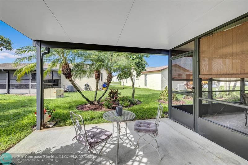 7359 Pine Park Drive North Lake Worth, FL 33467 - Photo 30 of 47 a view of a porch with chairs and backyard