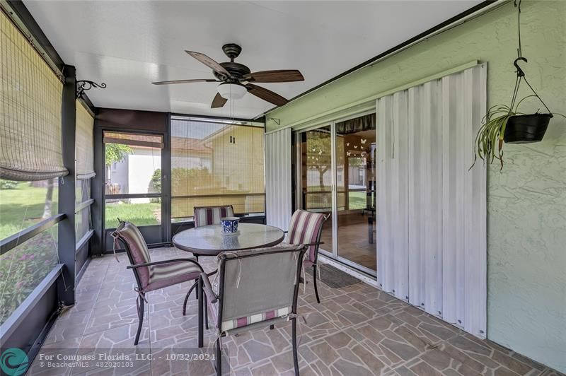 7359 Pine Park Drive North Lake Worth, FL 33467 - Photo 32 of 47 a dining room with furniture a chandelier and wooden floor
