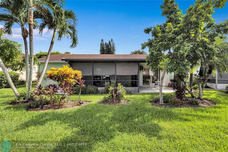 7359 Pine Park Drive North Lake Worth, FL 33467 - Photo 35 of 47 a view of a chair and table in backyard of the house