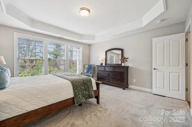 a bed room with a bed and a large window