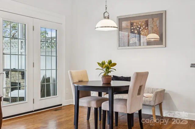 a view of a dining room with furniture and chandelier