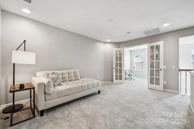 a living room with furniture and a lamp