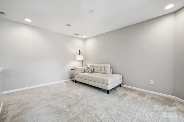 a living room with furniture and a night stand