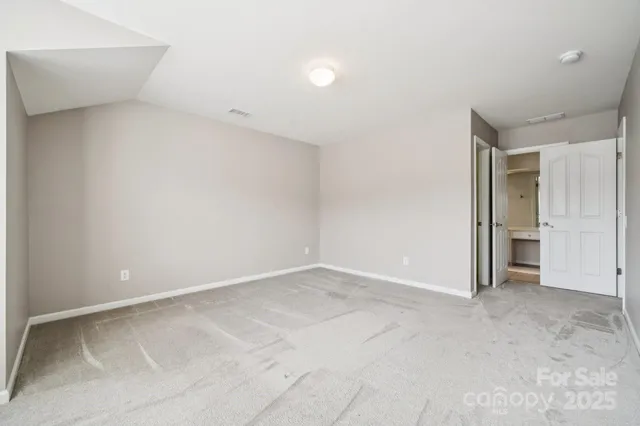 an empty room with closet area