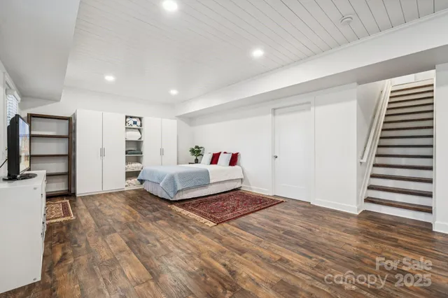 a spacious bedroom with a bed and a walk in closet