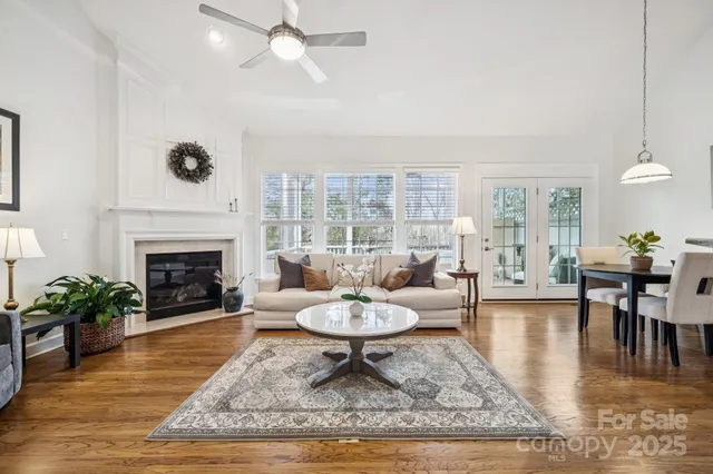 a living room with furniture a fireplace and a table