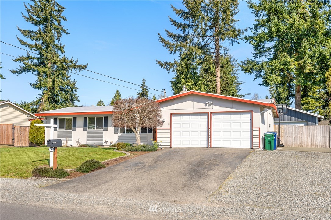 4612 Northeast 23rd Street Renton, WA 98059 - Photo 1 of 24 a front view of a house with a yard and garage