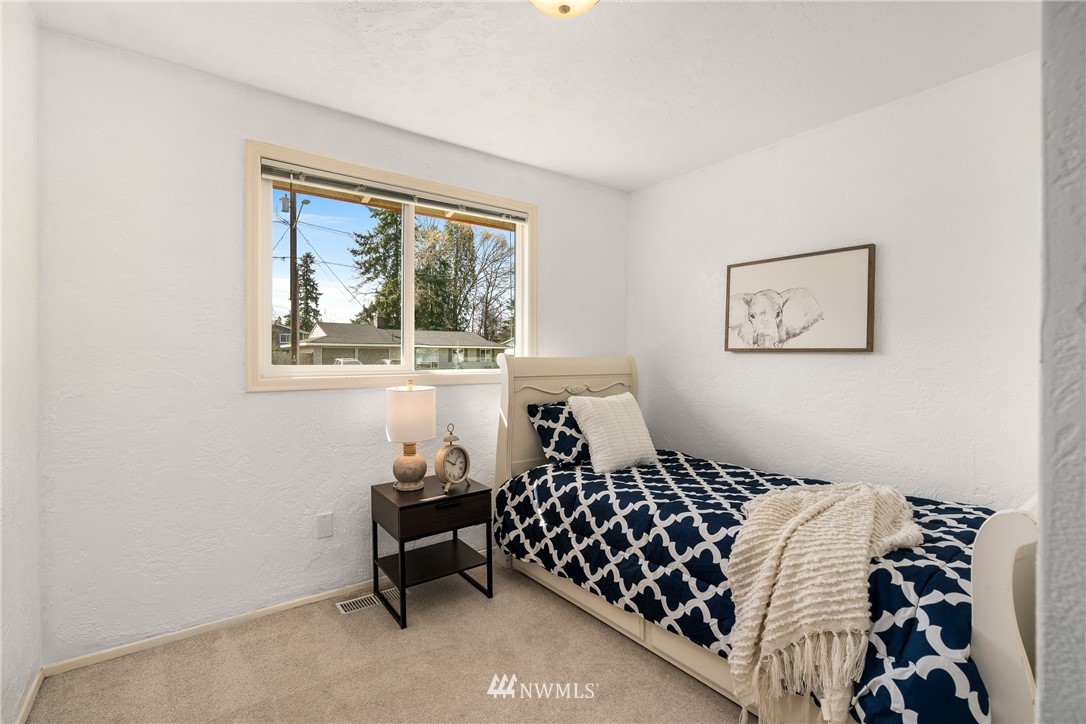 4612 Northeast 23rd Street Renton, WA 98059 - Photo 16 of 24 a bedroom with a bed and a window