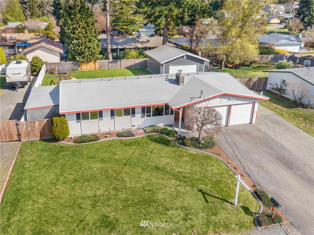 4612 Northeast 23rd Street Renton, WA 98059 - Photo 3 of 24 a view of a house with a big yard and large trees