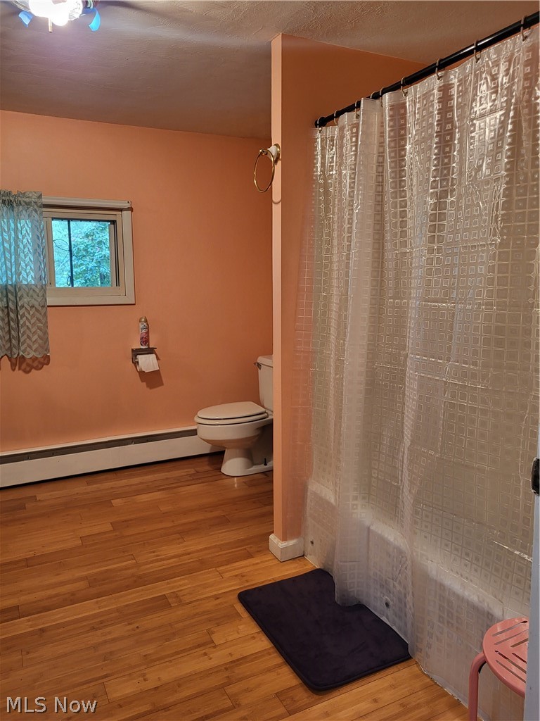 4445 Hamilton Road Medina, OH 44256 - Photo 12 of 41 Bathroom featuring hardwood / wood-style flooring, baseboard heating, and toilet