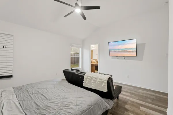 a bedroom with a bed and wooden floor