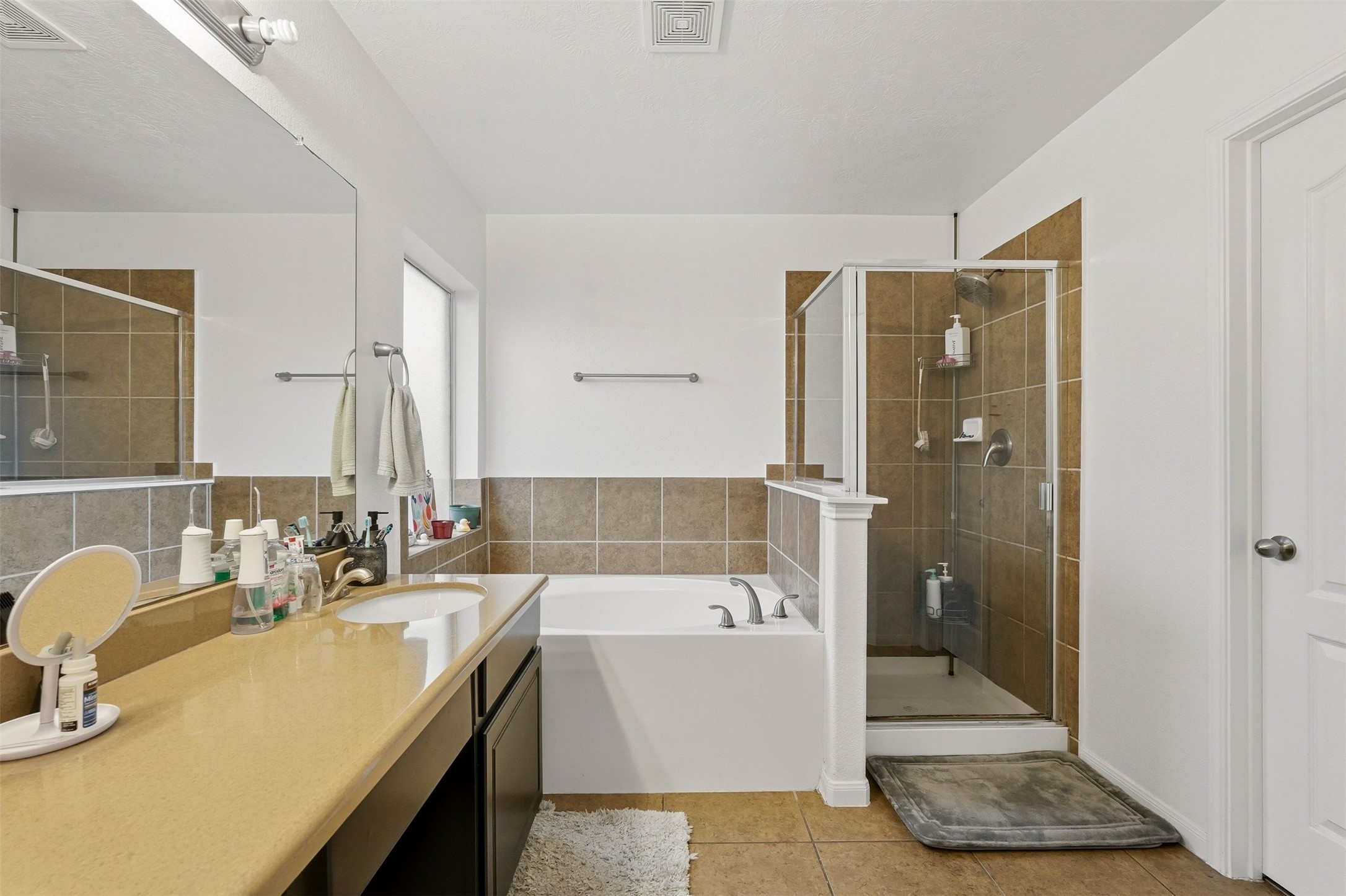 16518 Dover Mills Drive Spring, TX 77379 - Photo 19 of 28 a bathroom with a tub sink and mirror