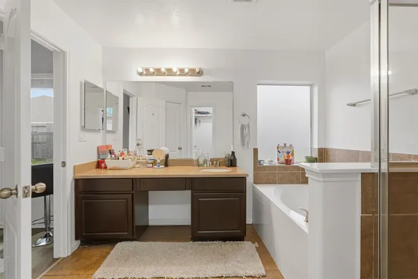 a view of cabinets a sink and a refrigerator in a bathroom