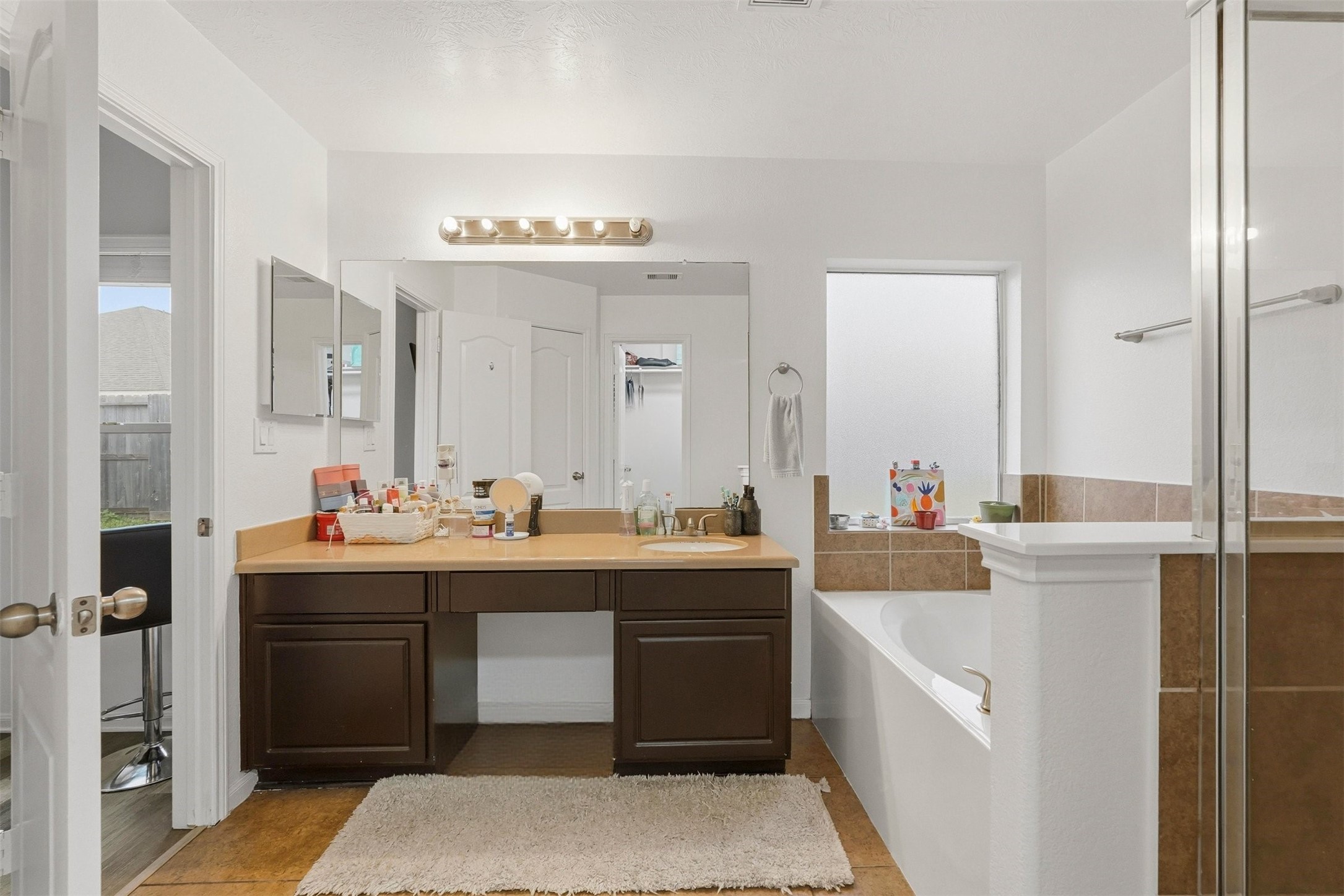16518 Dover Mills Drive Spring, TX 77379 - Photo 20 of 28 a view of cabinets a sink and a refrigerator in a bathroom