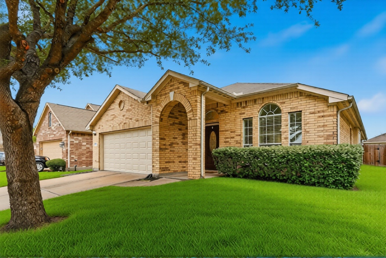 16518 Dover Mills Drive Spring, TX 77379 - Photo 2 of 28 a front view of a house with a garden