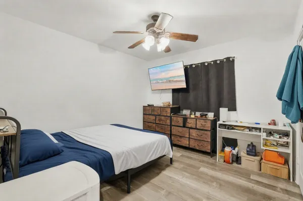 a bedroom with a bed and a chandelier