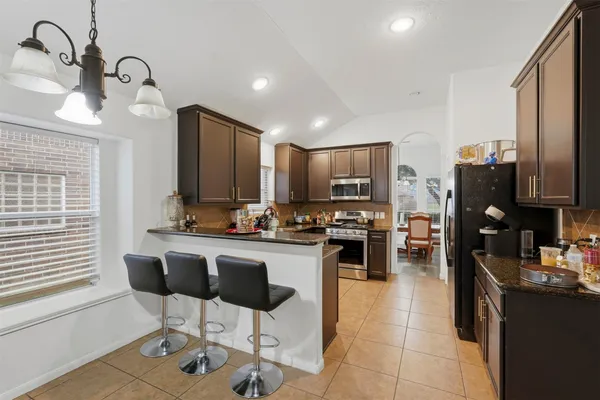 a kitchen with counter space cabinets and appliances