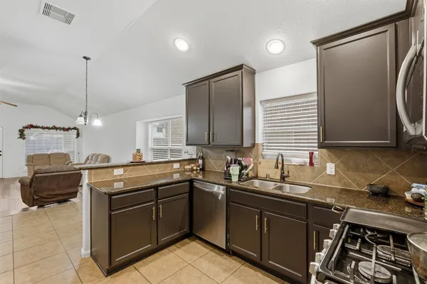 a kitchen with a sink stove and refrigerator