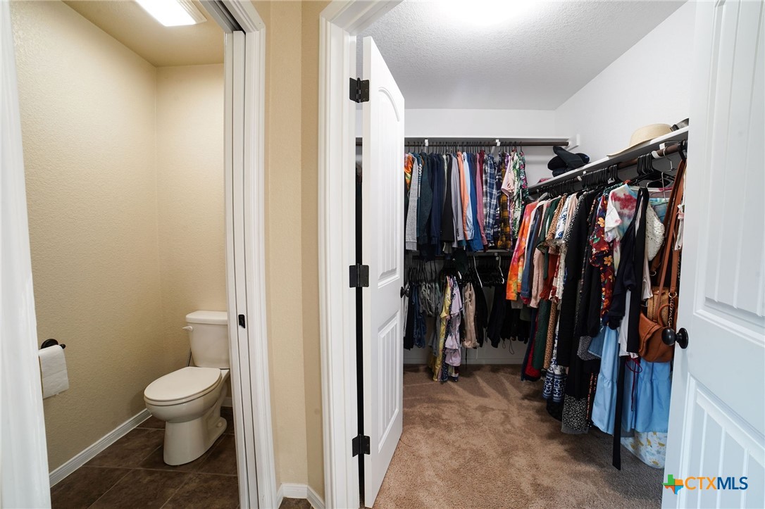 3422 Doss Street Copperas Cove, TX 76522 - Photo 19 of 29 a view of walk in closet with clothes and shoes
