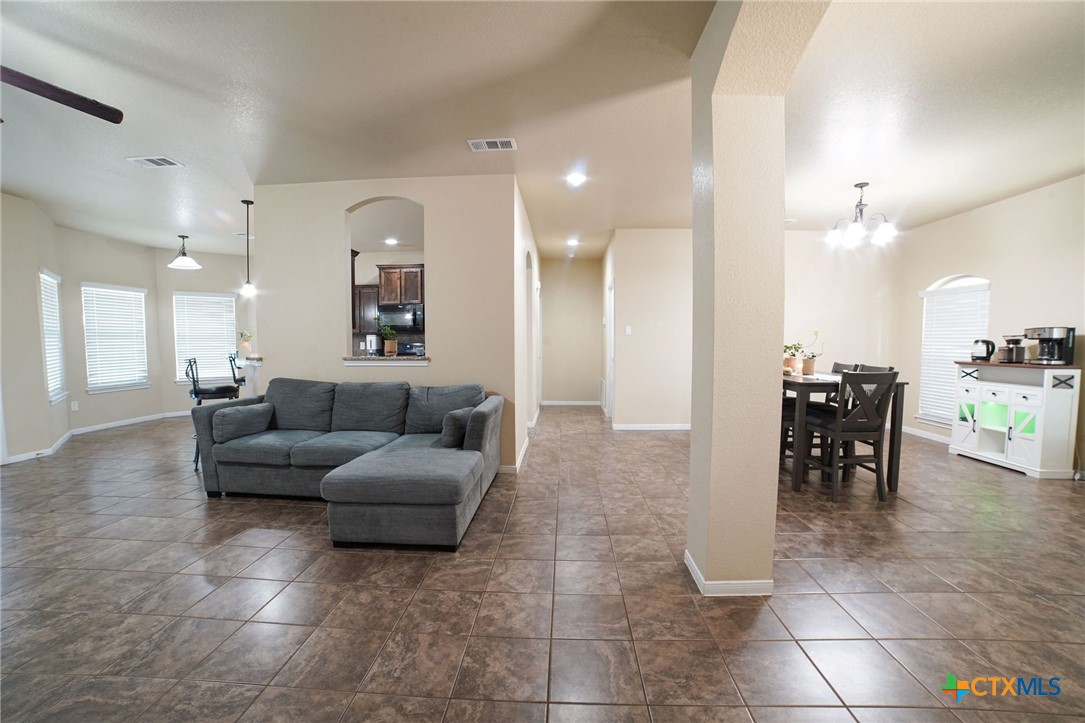3422 Doss Street Copperas Cove, TX 76522 - Photo 7 of 29 a living room with furniture and a dining table with kitchen view
