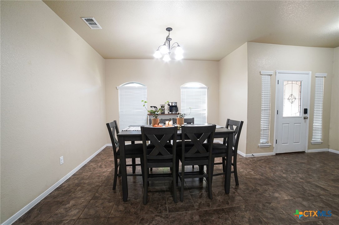 3422 Doss Street Copperas Cove, TX 76522 - Photo 8 of 29 a view of a dining room with furniture and chandelier