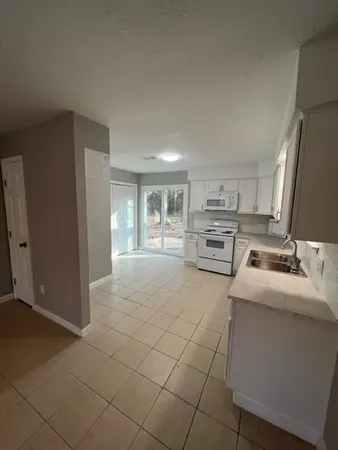 a kitchen with stainless steel appliances granite countertop a refrigerator sink and cabinets