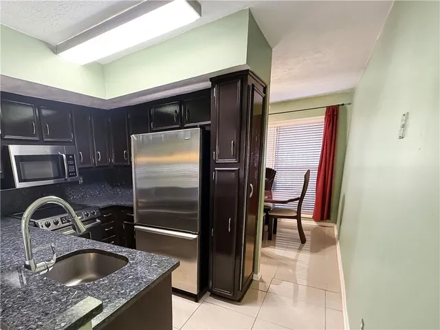 a kitchen with a refrigerator and a sink