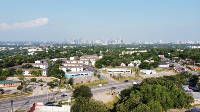 1189 Ridge Drive Austin, TX 78721 - Photo 1 of 4 an aerial view of residential houses with city view