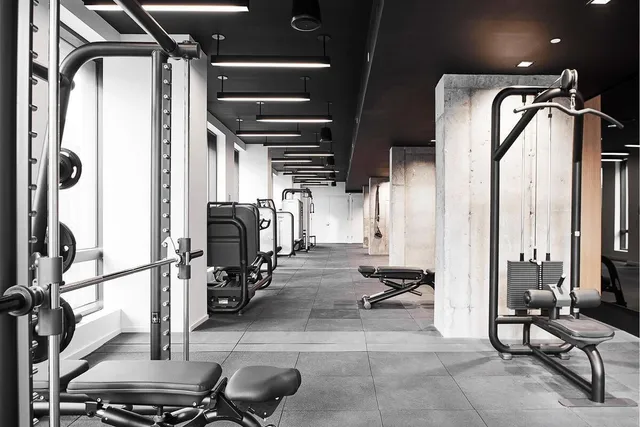 a living room with furniture a rug and white walls