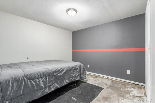 a bed sitting in a bedroom next to a cabinet