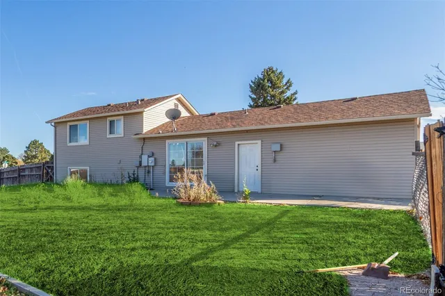 a front view of a house with a yard and pathway