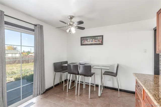 a view of a dining room with furniture and a window