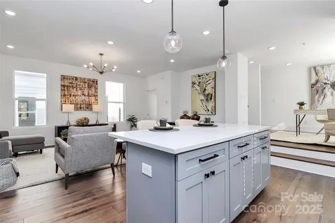 a kitchen with a sink stove top oven and cabinets