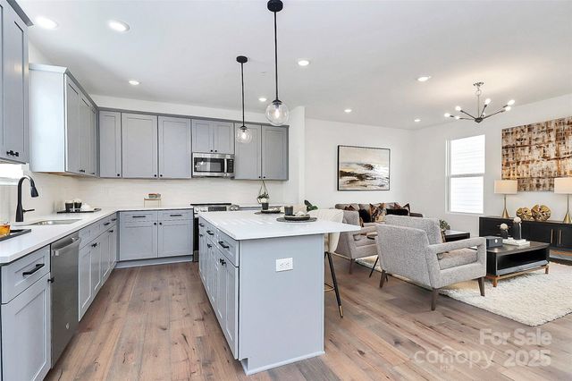 a kitchen with a sink cabinets and window